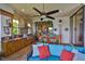 This covered outdoor kitchen has a grill, sink, dining table and comfortable seating for your cooking and dining pleasure at 5417 Tybee Island Dr, Apollo Beach, FL 33572