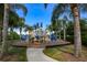 Vibrant blue playground equipment nestled among mature palm trees, offering a fun and safe play area at 5417 Tybee Island Dr, Apollo Beach, FL 33572