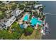 Aerial view of community pool with beach entry, swimming lanes, spa, and lighthouse feature overlooking the water at 5417 Tybee Island Dr, Apollo Beach, FL 33572