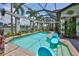 The screened swimming pool includes an inground spa, floating lounge chairs, and views of the intercoastal waterway at 5417 Tybee Island Dr, Apollo Beach, FL 33572