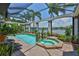Relaxing screened-in pool and spa area overlooking the canal, perfect for outdoor entertainment and tranquility at 5417 Tybee Island Dr, Apollo Beach, FL 33572