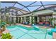 The backyard features an oversized pool and deck, with lounge chairs and an outdoor dining area at 5417 Tybee Island Dr, Apollo Beach, FL 33572