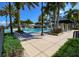 Resort-style pool area with lounge chairs, cabana and well-manicured landscaping, creating a relaxing oasis at 5417 Tybee Island Dr, Apollo Beach, FL 33572