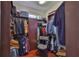 This modern walk-in closet has custom shelving, built-in storage, and a zebra print accent chair at 5417 Tybee Island Dr, Apollo Beach, FL 33572