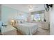 Bright bedroom with beachy decor features a window for natural light and beach-themed curtains at 600 71St Ave # 16, St Pete Beach, FL 33706