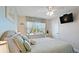 Bedroom boasts a calming atmosphere with light blue walls, beachy decor, and a ceiling fan at 600 71St Ave # 16, St Pete Beach, FL 33706