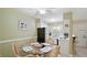Cozy dining area adjacent to the kitchen, furnished with a glass-top table and wicker chairs at 600 71St Ave # 16, St Pete Beach, FL 33706
