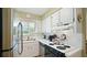 Well-maintained kitchen with white cabinetry, black appliances, and ample counter space at 600 71St Ave # 16, St Pete Beach, FL 33706