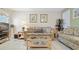 Comfortable living room with plush seating, stylish decor, and tile flooring at 600 71St Ave # 16, St Pete Beach, FL 33706