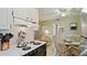 A partial view of the kitchen, living and dining spaces and a glimpse into the bathroom at 600 71St Ave # 16, St Pete Beach, FL 33706