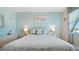 Serene main bedroom with light blue walls, coordinated decor, and natural light at 600 71St Ave # 16, St Pete Beach, FL 33706