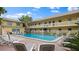 Inviting community pool surrounded by lounge chairs and lush tropical landscaping at 600 71St Ave # 16, St Pete Beach, FL 33706