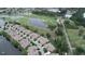 Scenic aerial view showcases waterfront homes near a golf course with lush greenery and serene lakes at 611 Tremont Greens Ln, Sun City Center, FL 33573