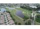 Scenic aerial view showcasing the golf course community with ponds, lush greenery, and well-maintained residential areas at 611 Tremont Greens Ln, Sun City Center, FL 33573
