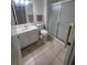 Clean bathroom with tile floors, glass shower, and vanity sink at 611 Tremont Greens Ln, Sun City Center, FL 33573