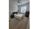 Cozy bedroom with carpet floors, ceiling fan, window, and furnishings at 611 Tremont Greens Ln, Sun City Center, FL 33573