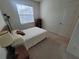 Bright bedroom features natural light, carpet, and a serene ambiance at 611 Tremont Greens Ln, Sun City Center, FL 33573