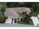 Charming single-story home features a well-manicured lawn, lush landscaping, and a two-car garage at 611 Tremont Greens Ln, Sun City Center, FL 33573