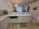 Clean, well-maintained kitchen featuring white appliances and convenient breakfast bar at 611 Tremont Greens Ln, Sun City Center, FL 33573