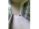 A covered patio with sliding glass doors to the home's interior at 611 Tremont Greens Ln, Sun City Center, FL 33573