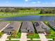 Aerial view of upscale homes next to a scenic pond with lush greenery, showcasing the community's beauty at 6123 Golden Nettle Dr, Apollo Beach, FL 33572