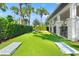 Community backyard featuring turf, cornhole boards, and a covered seating area, perfect for gatherings at 6123 Golden Nettle Dr, Apollo Beach, FL 33572