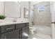 Modern bathroom with gray vanity, marble tile and shower-tub combo, creating a stylish and functional space at 6123 Golden Nettle Dr, Apollo Beach, FL 33572
