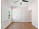 Bright bedroom with a ceiling fan, hardwood floors, closet, and natural light at 6123 Golden Nettle Dr, Apollo Beach, FL 33572