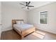 Well-lit bedroom with a ceiling fan, hardwood floors and window with exterior view creating a cozy space at 6123 Golden Nettle Dr, Apollo Beach, FL 33572