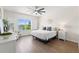 Bright bedroom with ceiling fan, hard wood floors, and a window overlooking the lake at 6123 Golden Nettle Dr, Apollo Beach, FL 33572