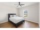 Comfortable bedroom featuring a ceiling fan, window and hardwood floors, offering a peaceful retreat at 6123 Golden Nettle Dr, Apollo Beach, FL 33572