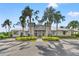 Beautiful clubhouse entrance featuring lush landscaping, palm trees, and prominent signage for easy identification at 6123 Golden Nettle Dr, Apollo Beach, FL 33572