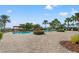 Beautiful community pool area with multiple seating areas, palm trees, lush landscaping, and lounge chairs at 6123 Golden Nettle Dr, Apollo Beach, FL 33572