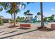 Resort style pool area featuring a splash pad, slide, plenty of lounge seating, and surrounding palm trees at 6123 Golden Nettle Dr, Apollo Beach, FL 33572