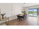 Dining room with modern chandelier and a view of the pool at 6123 Golden Nettle Dr, Apollo Beach, FL 33572