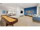 Spacious game room featuring a shuffleboard table, comfortable seating, and a large television for entertainment at 6123 Golden Nettle Dr, Apollo Beach, FL 33572