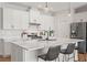 Bright kitchen with white cabinets, an island, and stainless steel appliances at 6123 Golden Nettle Dr, Apollo Beach, FL 33572