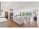 Open-concept kitchen with an island, and stainless steel appliances with scenic views of the lake and backyard at 6123 Golden Nettle Dr, Apollo Beach, FL 33572