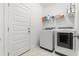 Bright laundry room has tile flooring and modern, front-loading washer and dryer at 6123 Golden Nettle Dr, Apollo Beach, FL 33572