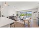 Open-concept living room and dining area with stylish furnishings and plenty of natural light and lake view at 6123 Golden Nettle Dr, Apollo Beach, FL 33572