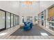 Brightly lit resident lounge with comfortable seating, tall ceilings, and glass enclosed office spaces at 6123 Golden Nettle Dr, Apollo Beach, FL 33572