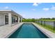 Inviting in-ground pool with lakeside views, perfect for relaxation and outdoor enjoyment on a sunny day at 6123 Golden Nettle Dr, Apollo Beach, FL 33572
