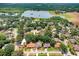 Neighborhood aerial showcasing tree lined streets and proximity to nearby lake and farmland at 613 Sportsman Park Dr, Seffner, FL 33584