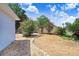 Secluded backyard offers a stone path, flowering bushes, and well-maintained mulch bed for relaxing outdoor living at 613 Sportsman Park Dr, Seffner, FL 33584