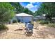 Secluded backyard with stone patio and comfortable seating around a fire pit at 613 Sportsman Park Dr, Seffner, FL 33584