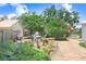 Lush backyard with mature trees, landscaping, and a cozy seating area at 613 Sportsman Park Dr, Seffner, FL 33584