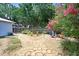 Expansive backyard featuring lush landscaping, paved walkways, and a cozy fire pit area for outdoor enjoyment at 613 Sportsman Park Dr, Seffner, FL 33584