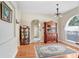 Well-lit dining room with hardwood floors, antique cabinets, and an arched doorway at 613 Sportsman Park Dr, Seffner, FL 33584