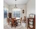 Cozy dining room featuring a round wood table, vintage furnishings, and natural light at 613 Sportsman Park Dr, Seffner, FL 33584
