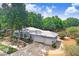 Charming single-story home with a metal roof, two-car garage, and mature landscaping at 613 Sportsman Park Dr, Seffner, FL 33584